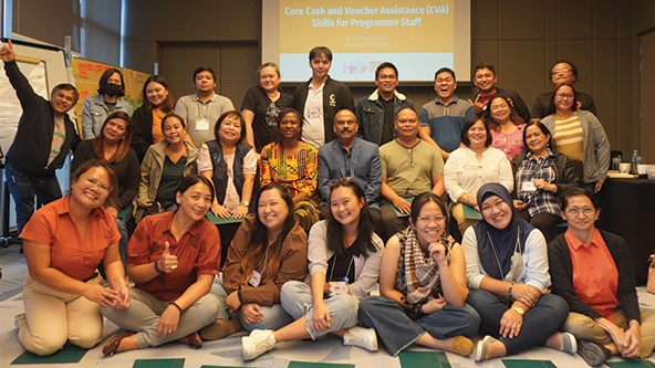 Group photo of CARE partners at a staff training