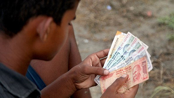 Teenage boy counting money close up