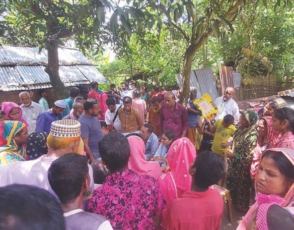 group of people standing outside small buildings and a fence