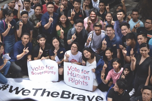 group of young people with signs that read 