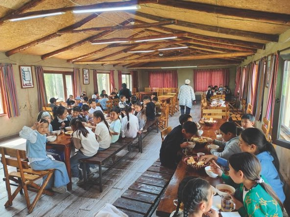 students having a meal in a school building in Kyrgyzstan's Kemin region