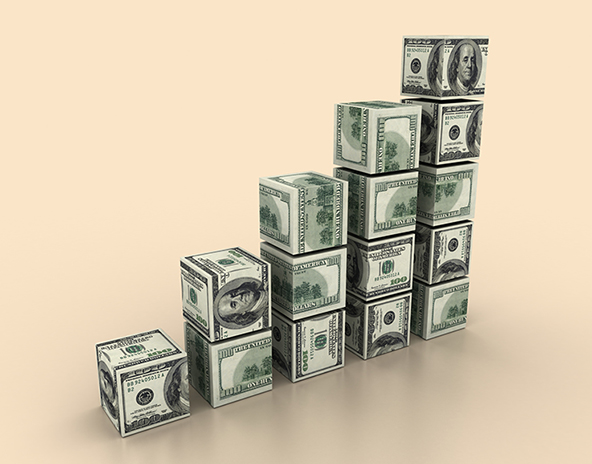 A row of stacked blocks covered in $100 bills