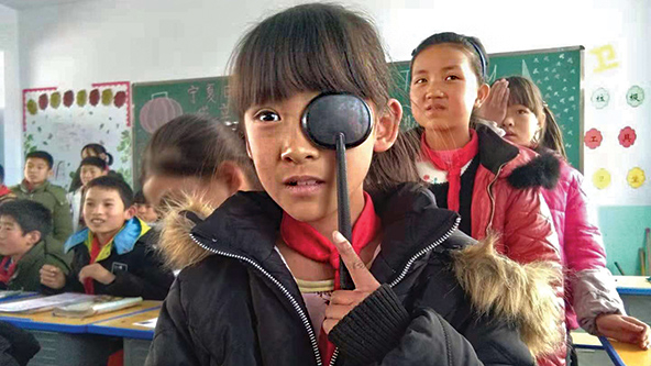 A student taking an eye exam in rural China.