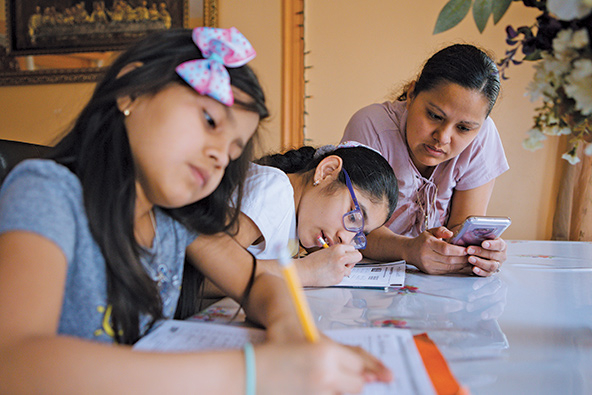 Woman sitting with her two daughters