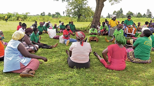 Ugandan women sitting in a circle for a dialogue session