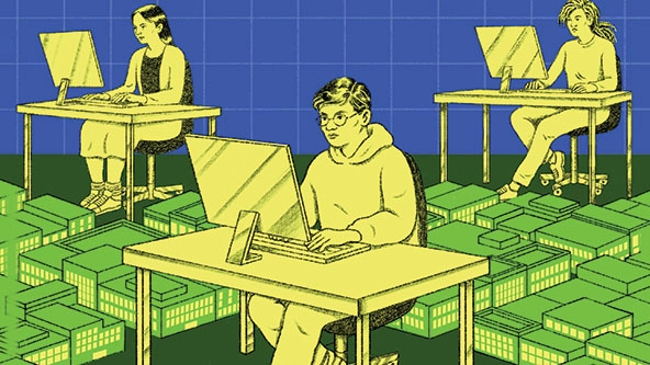 People sitting a desks with computers