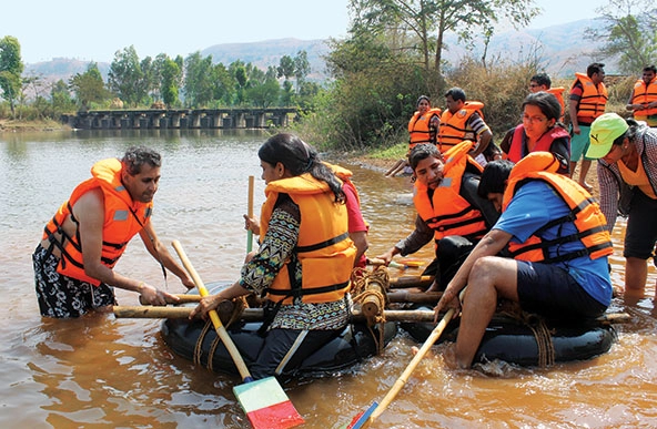 People sitting in a raft near the shoreline.