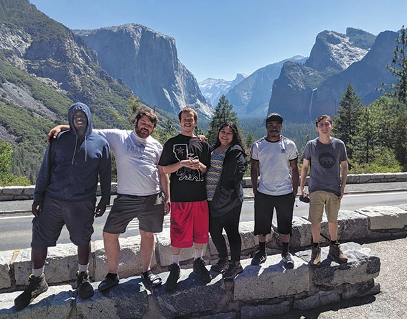 Six young people at Yosemite Tunnel and mountains in background