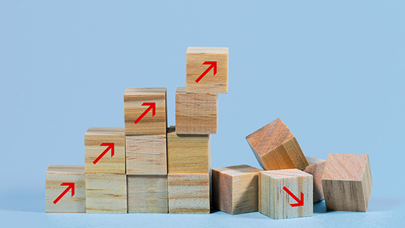 Collapsed stair structure of wooden cubes with upward pointing arrows
