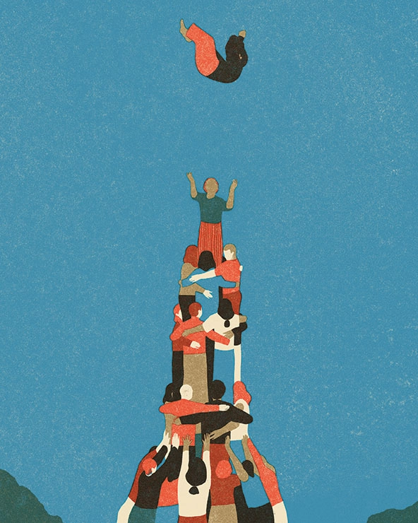 human pyramid tossing a person up in the air