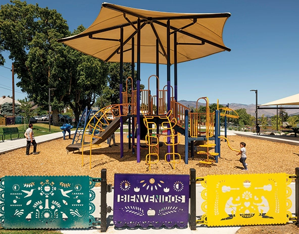 playground climbing equipment under a large umbrella
