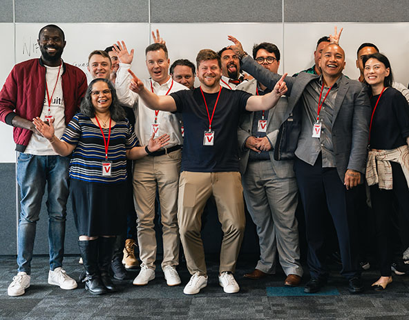 group of people standing together and smiling at the camera
