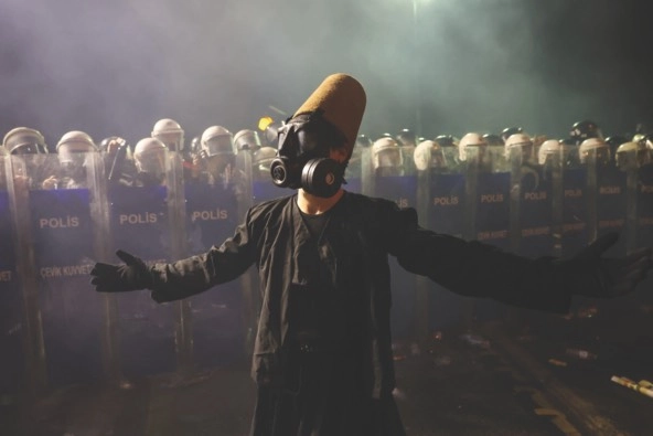 photo of a protester wearing a Sufi whirling dervish costume in the country Turkey