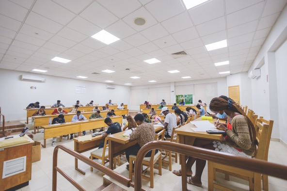 students sitting at desks in a brightly lit classroom