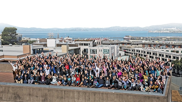 Arial photo of a group of people standing on a rooftop.