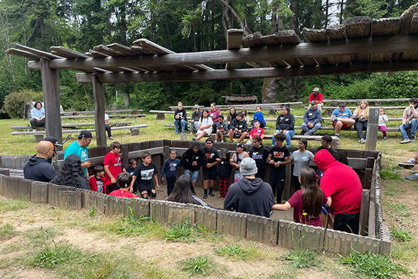 Young people gathered in a circle in a park