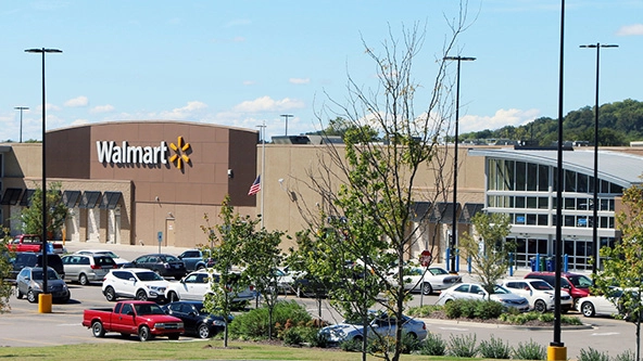 The exterior of a large Walmart store and parking lot