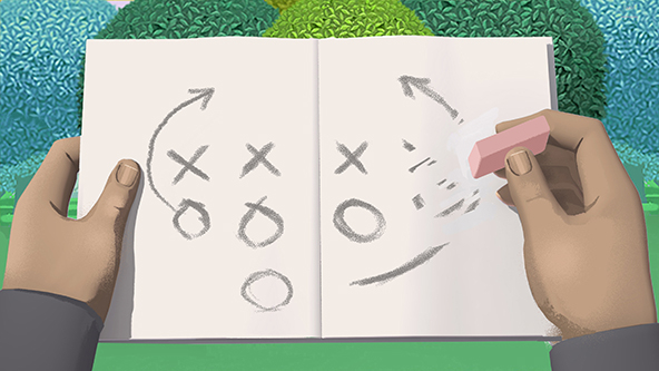 Hands holding a playbook with one hand erasing the play.