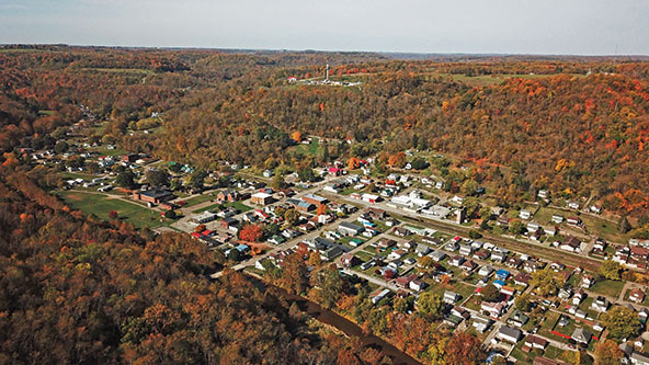 An aerial view of Dillonvale, Ohio, showing houses, buildings, streets, and wooded areas