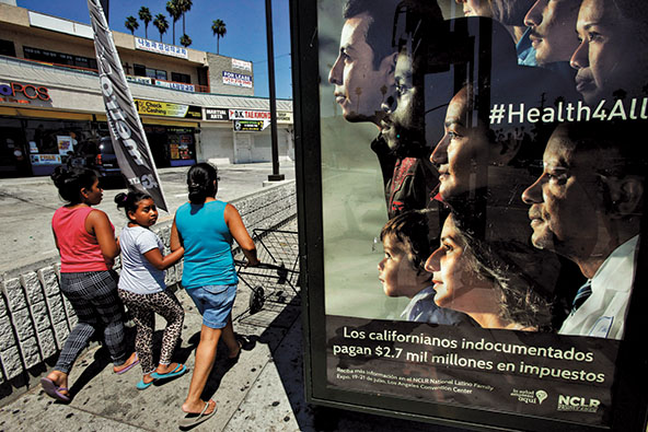 People walk by a sign that says 