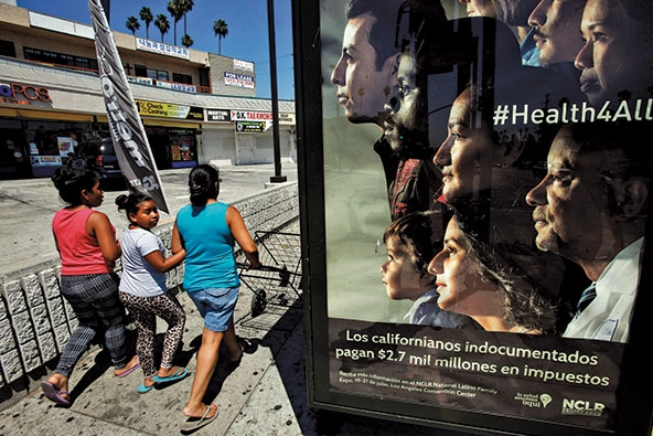 People walk by a sign that says 