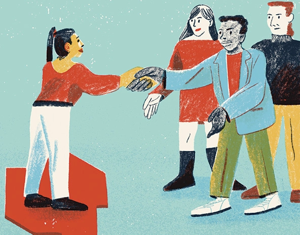 One person reaches out from a group to shake another person's hand