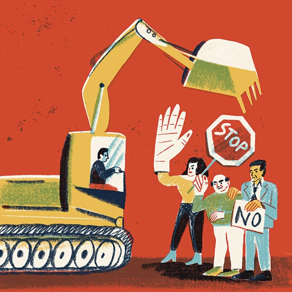 Bulldozer approaching people with signs that say 