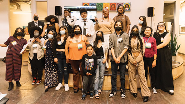 young people standing on and in front of a stage