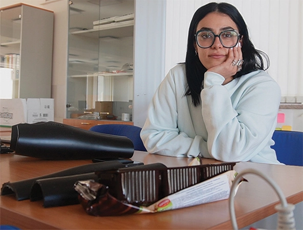 Woman sitting at a table with protheses