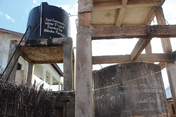 a water tower resting on a concrete frame