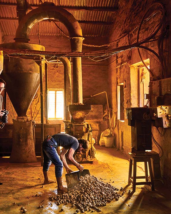 man dumping out a container of tumeric on the floor