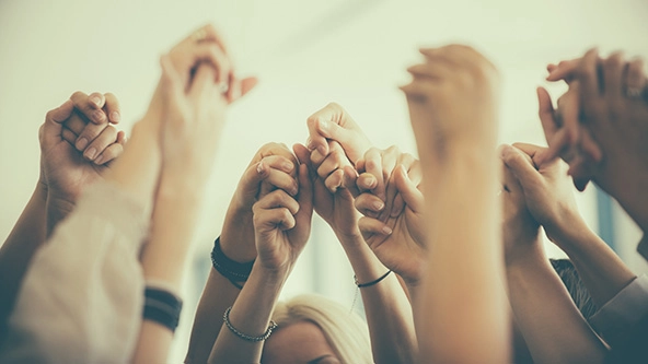 group of women holding hands