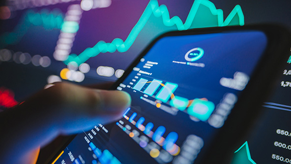 A business professional using a tablet with financial model charts