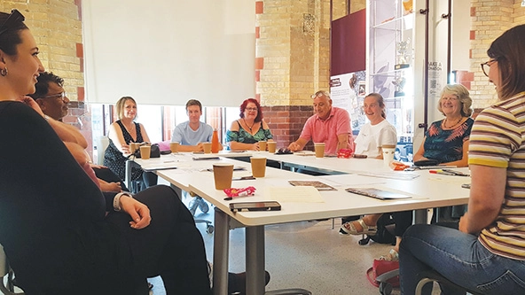 Men and women sitting around a conference table